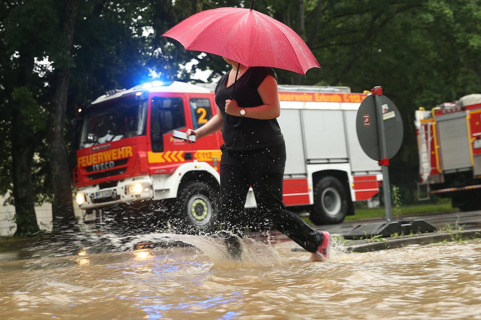 Eine Frau auf der Morper Allee in Erkrath: Ein schweres Unwetter hat in der Stadt für Hochwasser gesorgt.