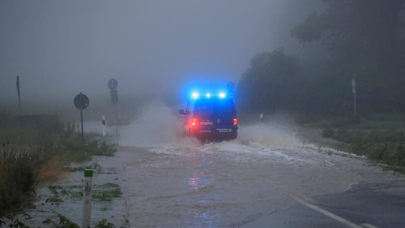 Ein Fahrzeug des Technischen Hilfswerks fährt durch die Fluten auf einer Straße neben der Erft: Der Rhein-Erft-Kreis rief am Donnerstag den Katastrophenfall aus.