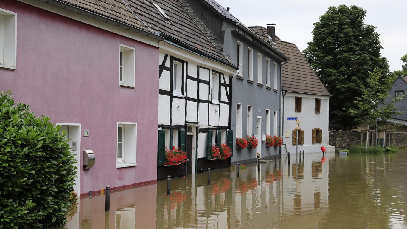 Das Wasser steht vor Häusern in Essen-Kettwig: Einsatzkräfte haben mehrere Gebäude im Stadtteil geräumt.