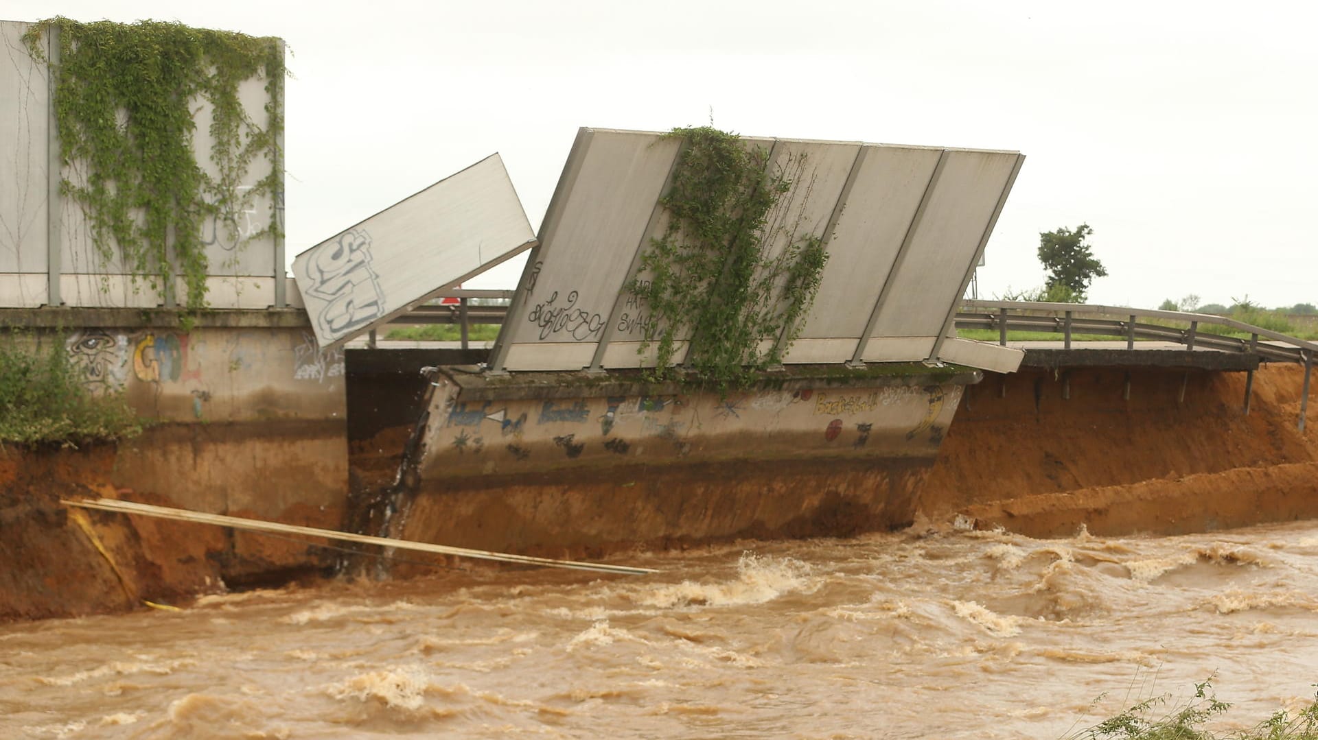 Ein Teil der Fahrbahn und der Lärmschutzwand stürzt in die Erft: Auch die Autobahn wurde von den Wassermassen nicht verschont.