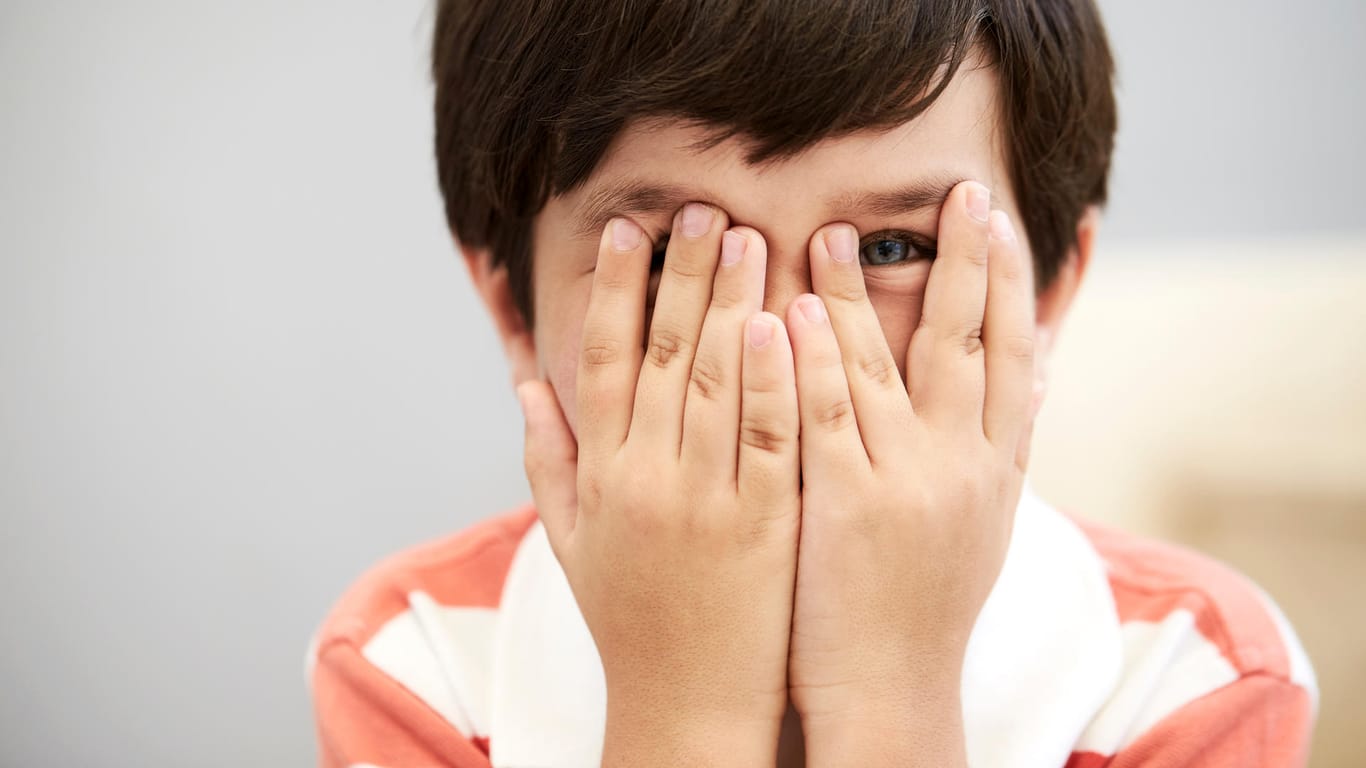 Ein Junge hält sich die Augen zu: Eine Bindehautentzündung kann ansteckend sein.