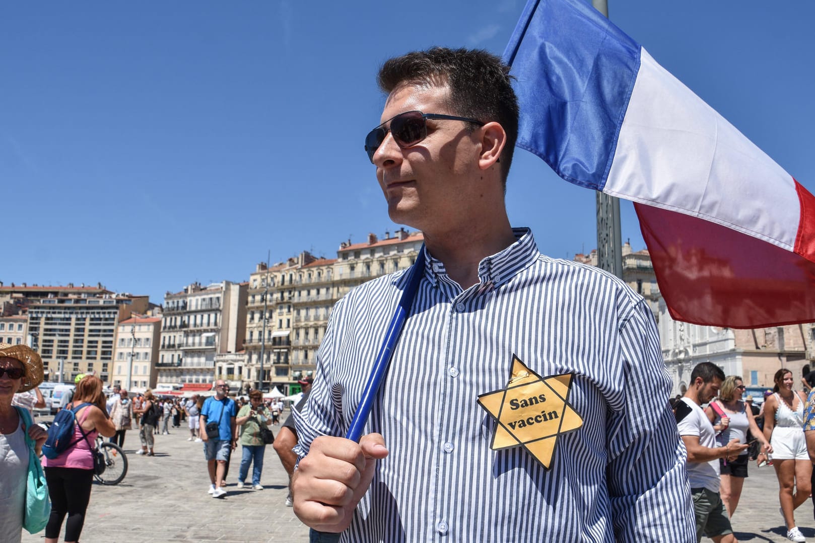 Marseille, Frankreich: Demonstrant mit französischer Flagge und Gelbem "Ungeimpft"-Stern.