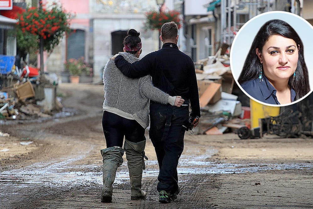 Zwei Menschen laufen Arm in Arm durch das Hochwassergebiet: Mehr als 150 Menschen starben durch die Flutkatastrophe in Deutschland.