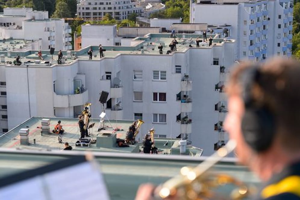 Blasmusiker spielen auf den Dächern von Hochhäusern