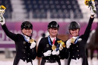 Dorothee Schneider (l-r), Isabell Werth und Jessica von Bredow-Werndl feiern ihr Team-Gold in der Dressur.