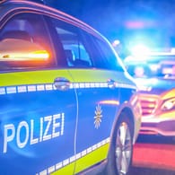 Polizeiwagen mit Blaulicht im Einsatz (Symbolbild): Noch in der Nähe des Tatorts nahmen Polizisten fünf Verdächtige vorläufig fest.