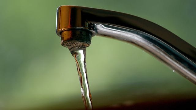 Leitungswasser fließt aus einem Wasserhahn.