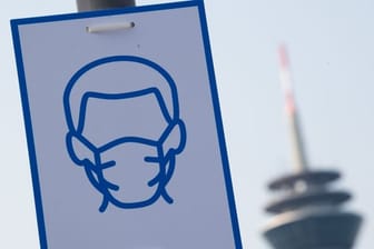 Ein Piktogramm mahnt in Düsseldorf das Einhalten der Maskenpflicht an.