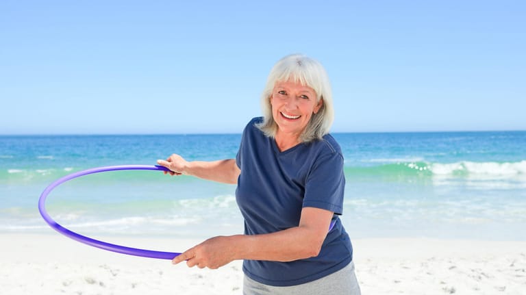 Hula-Hoop am Strand: Auch im Urlaub kann man die Hüften kreisen lassen.