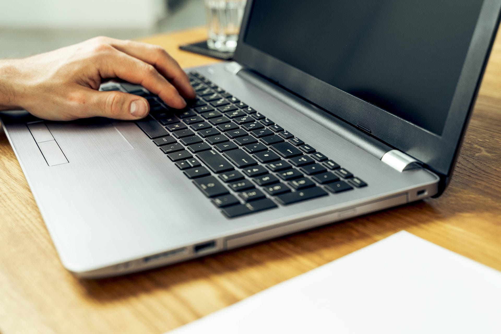 Augsburg, Bavaria, Germany - 18 may 2021: close up male hand typing on laptop