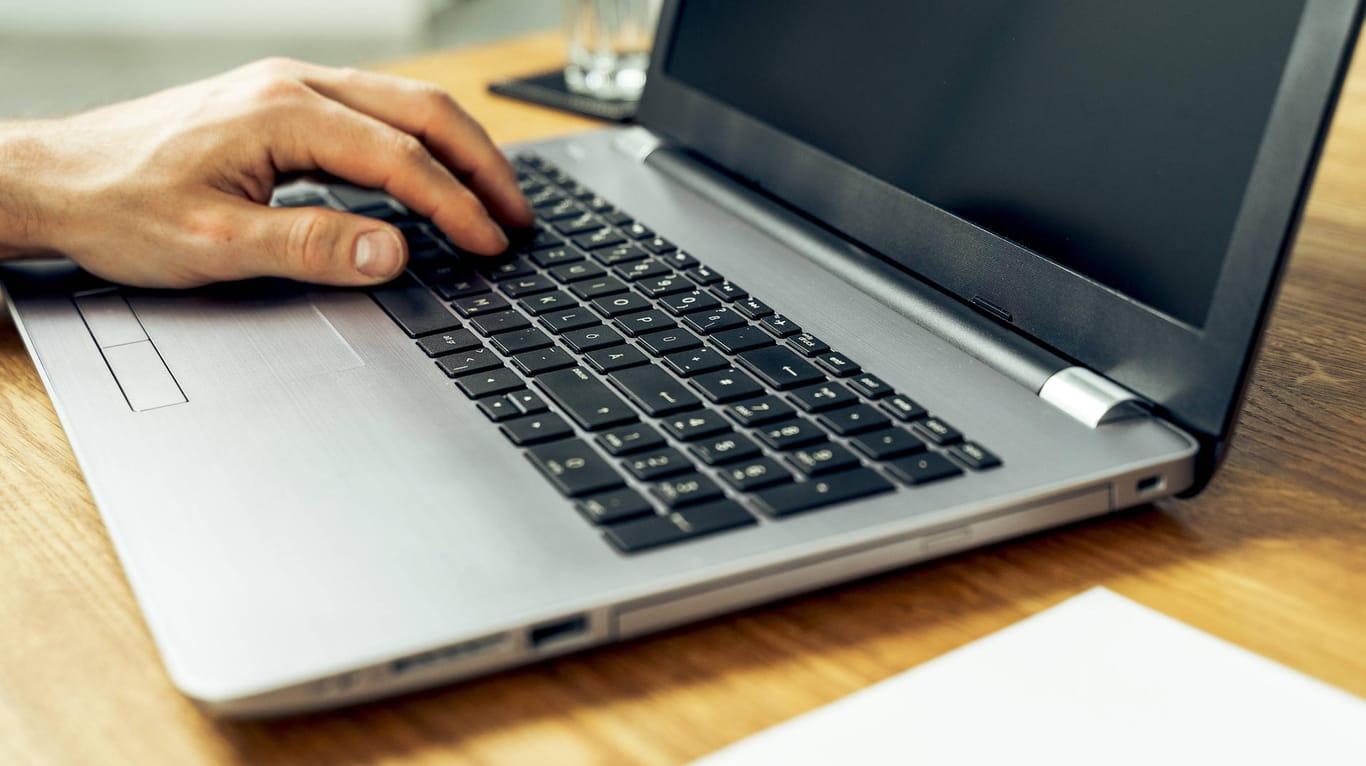 Augsburg, Bavaria, Germany - 18 may 2021: close up male hand typing on laptop