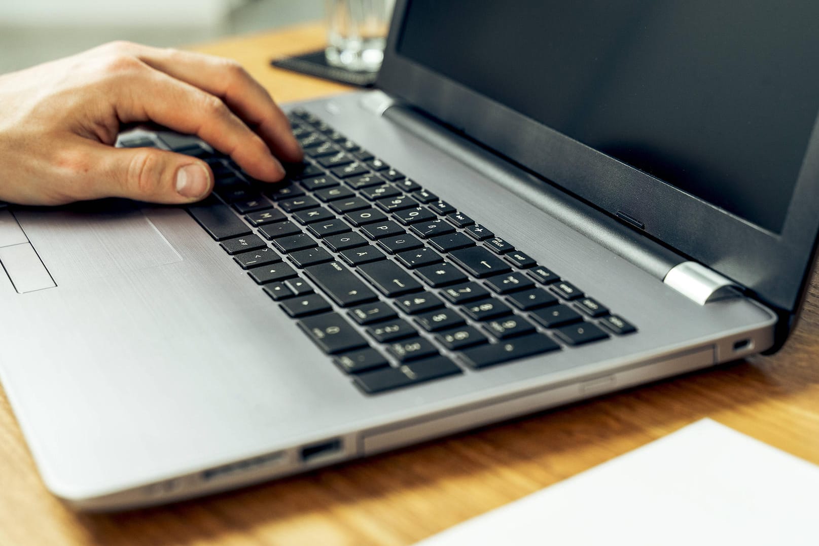 Augsburg, Bavaria, Germany - 18 may 2021: close up male hand typing on laptop