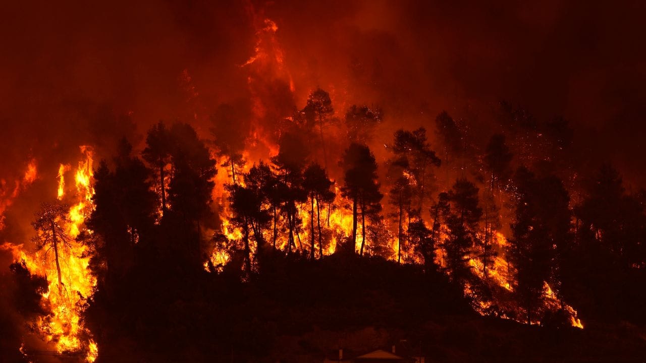 Flammen nähern sich dem Dorf Gouves auf der Insel Euböa. Flammen nähern sich dem Dorf Gouves auf der Insel Euböa.