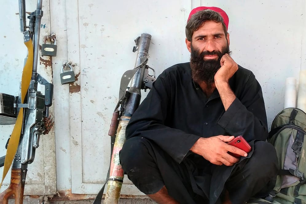Ein Taliban-Kämpfer sitzt im afghanischen Farah neben seinen Waffen: Die militant-islamistischen Taliban rücken schnell vor.