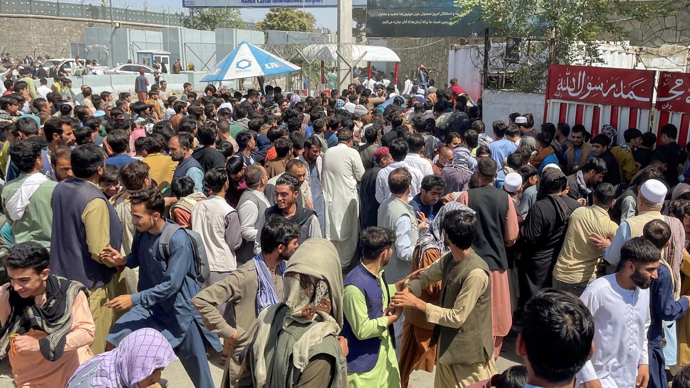 Szene am Hamid Karzai International Airport in Kabul, Afghanistan: Menschen versuchen, auf das Flughafengelände zu gelangen und das Land zu verlassen.