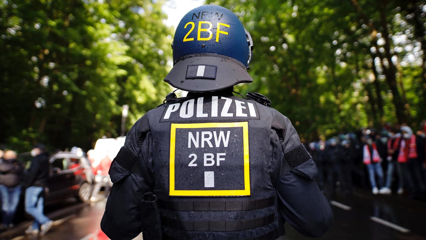 Ein Polizist mit Helm bei einem Einsatz in Köln (Symbolbild): Beamte wollen am Wochenende verstärkt den Bereich am Aachener Weiher kontrollieren.