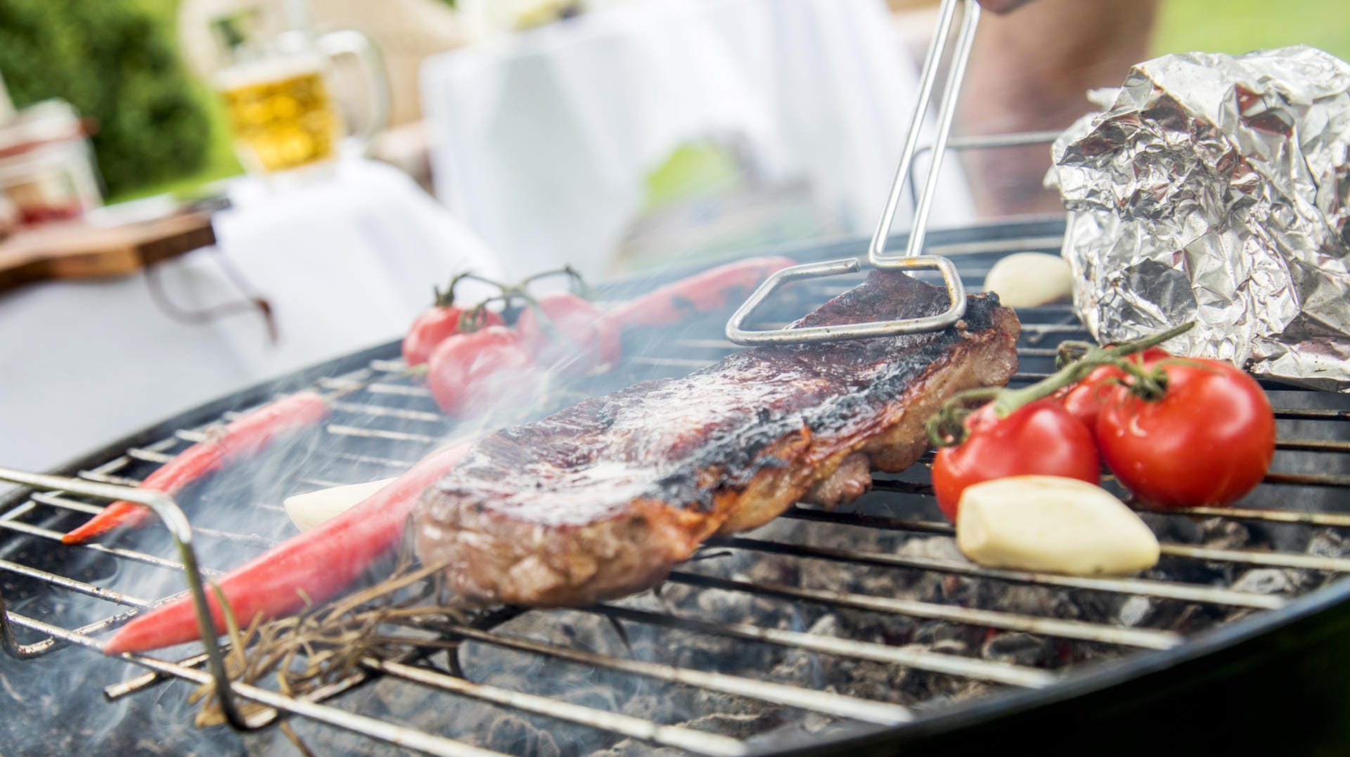 Qualmender Grill: Der Qualm und auch die Alufolie können zu Schadstoffen im Grillgut führen.