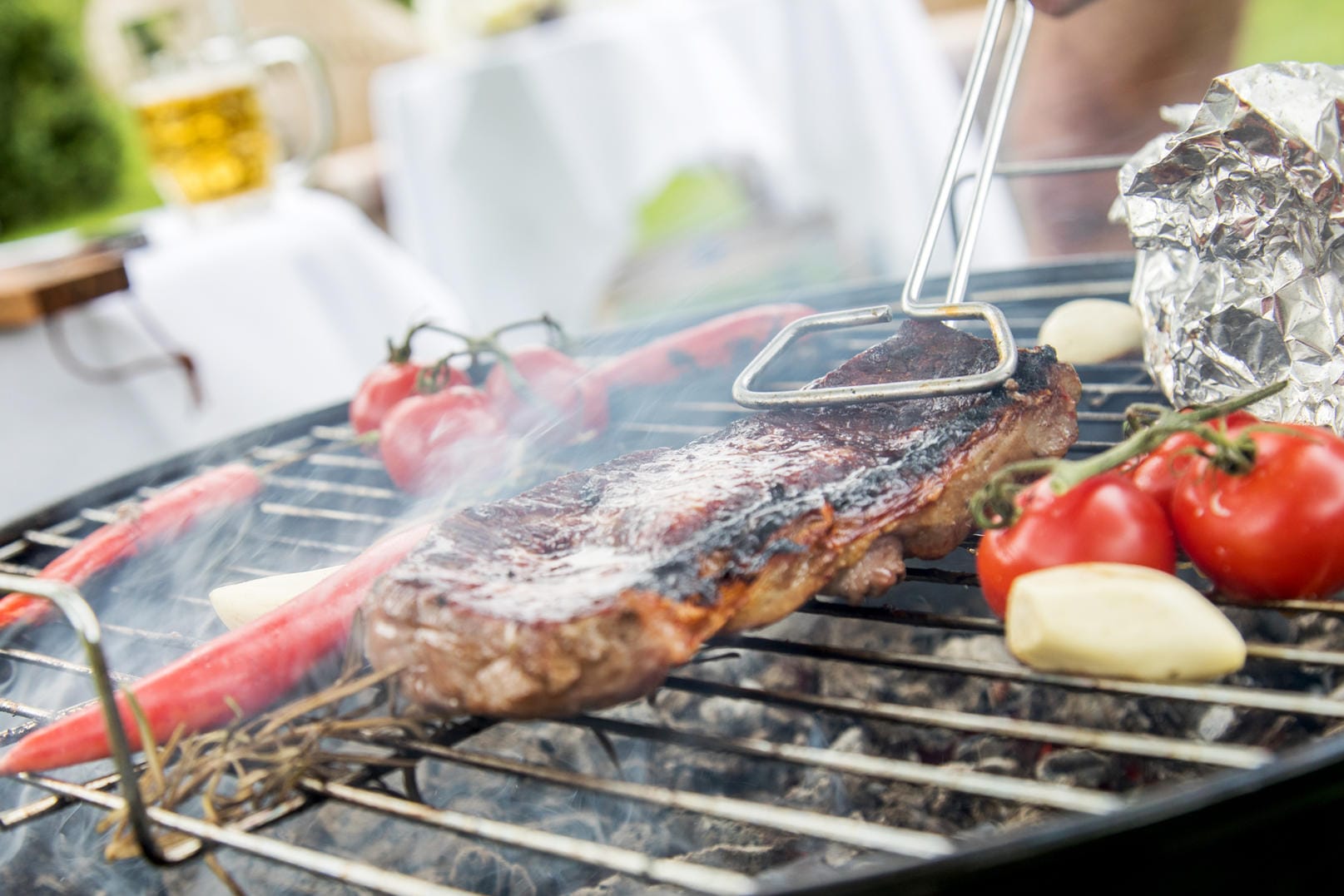 Qualmender Grill: Der Qualm und auch die Alufolie können zu Schadstoffen im Grillgut führen.