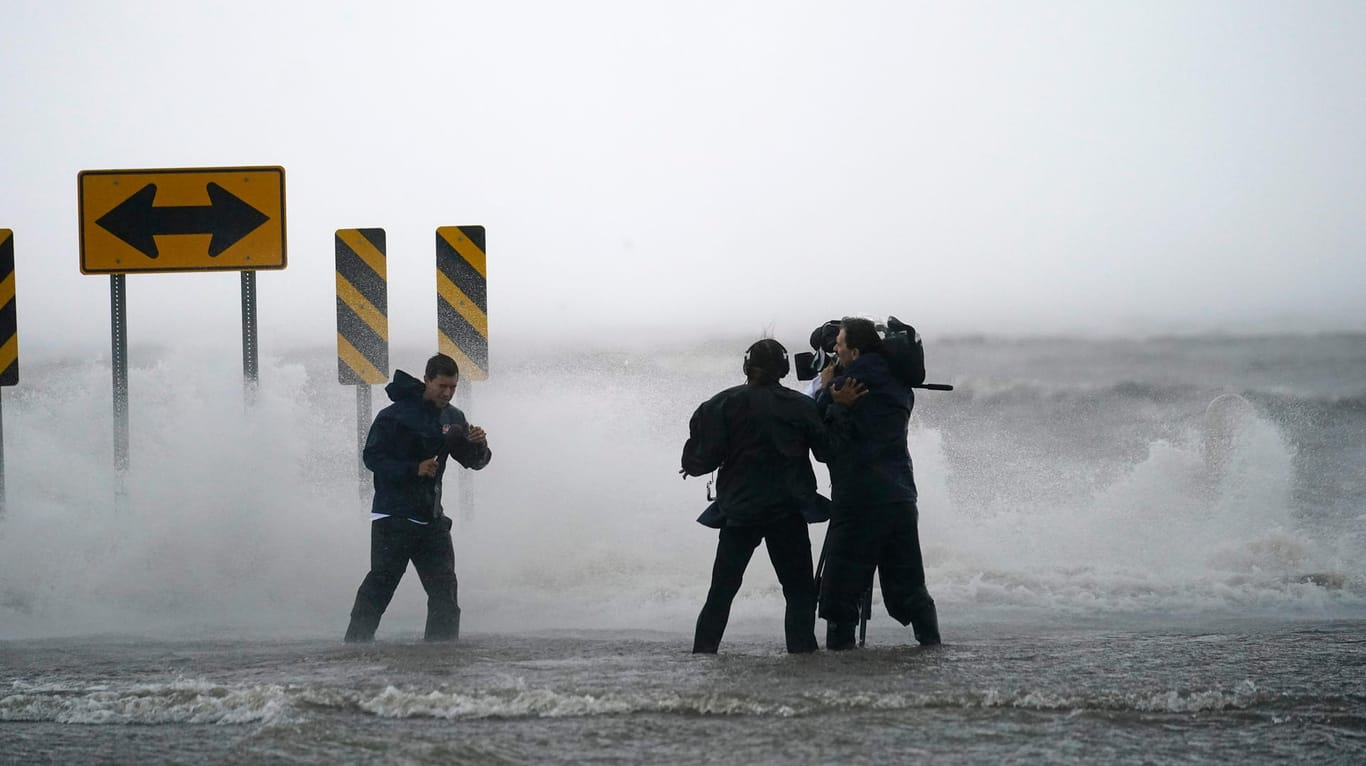 Ein Nachrichtenteam steht im Wasser des Lake Pontchartrains im US-Bundesstaat Louisiana: Der Hurrikan "Ida" hat den Bundesstaat im Süden des Landes erreicht.