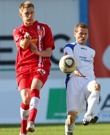 Hansa-Mittelfeldspieler Bradley Carnell (re.) spielt den Ball knapp vor Nils Petersen. (