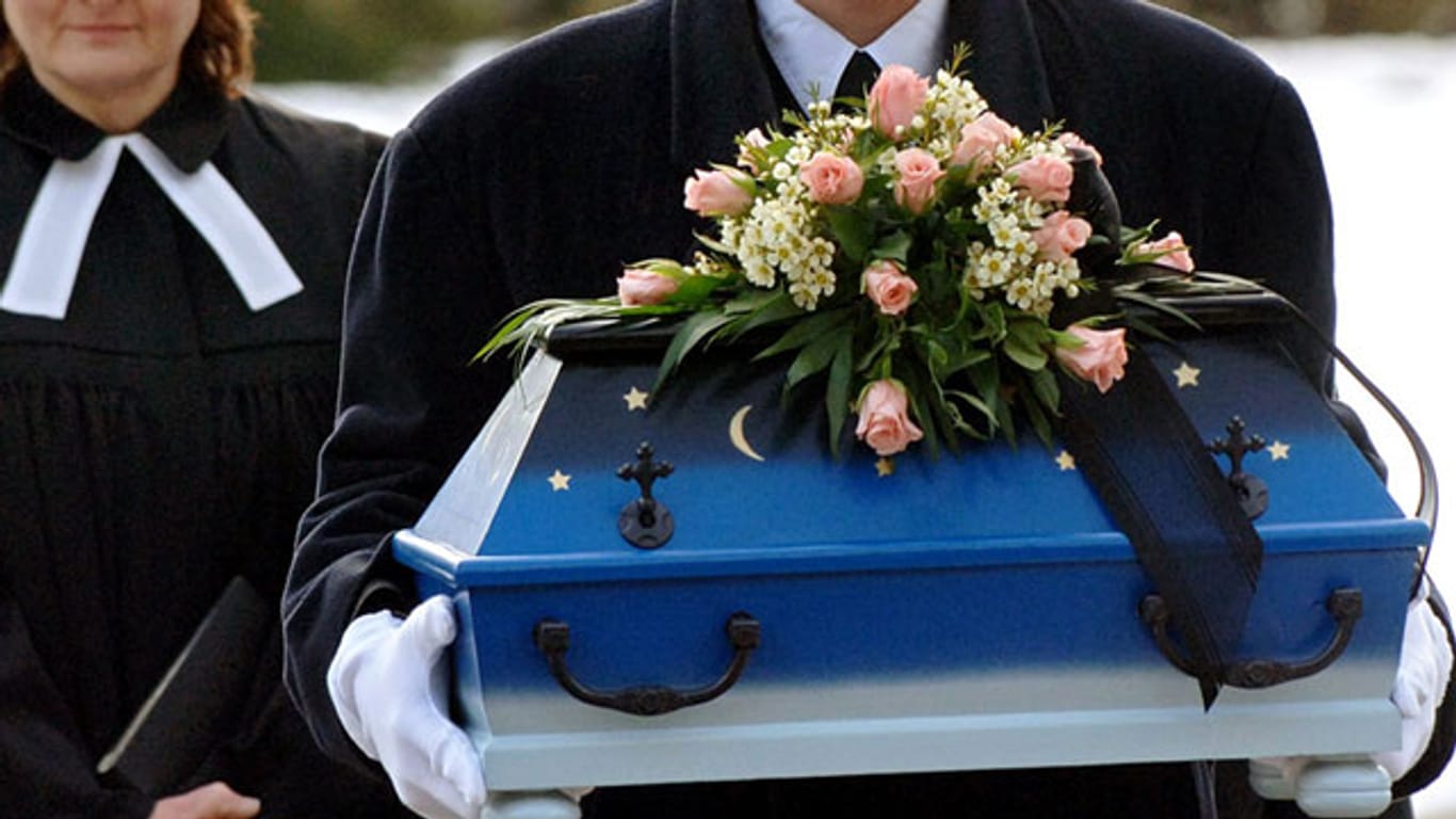 Ein Bestatter trägt im Jahr 2006 den Sarg eines kleinen Mädchens zum Grab, dessen Leiche in einer Müllsortieranlage gefunden wurde