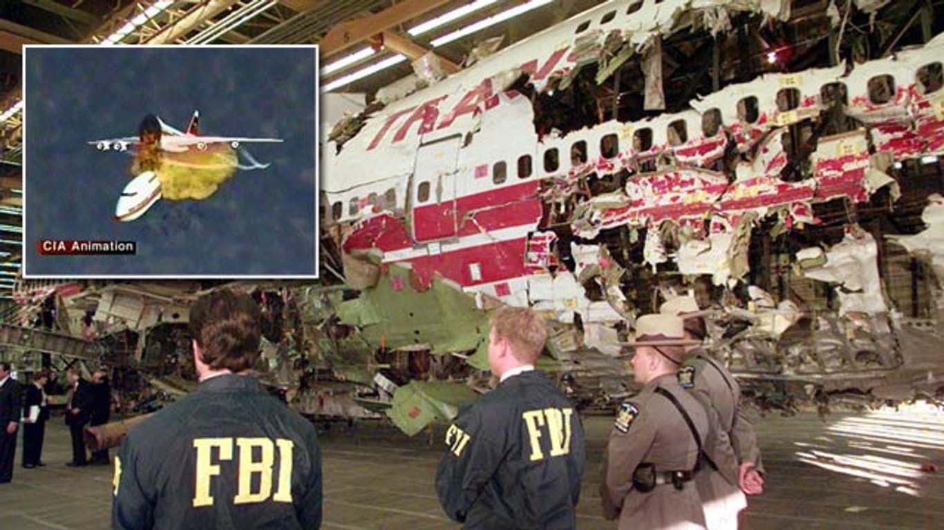 FBI-Agenten bewachen die Rekonstruktion des vor der US-Küste abgestürzten Flugzeugs. Links oben sehen Sie eine CIA-Animation des Unglücks.