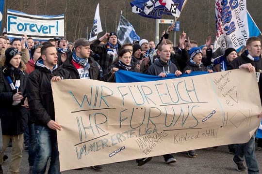 Fans des Hamburger SV demonstrieren bei einem Marsch zum Stadion ihre Solidarität.