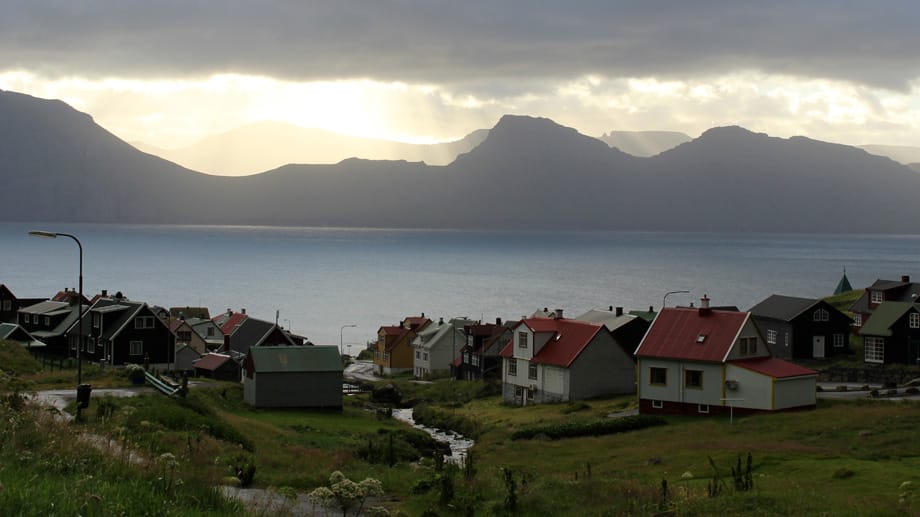 Die Sonne bricht in Gjógv hinter den Wolken hervor. Das Wetter auf den Färöer Inseln kann an einem Tag alle Extreme mitmachen.