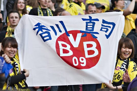 Japanische BVB-Fans mit einer entsprechend ihrer Landesfarben dekorierten Flagge.