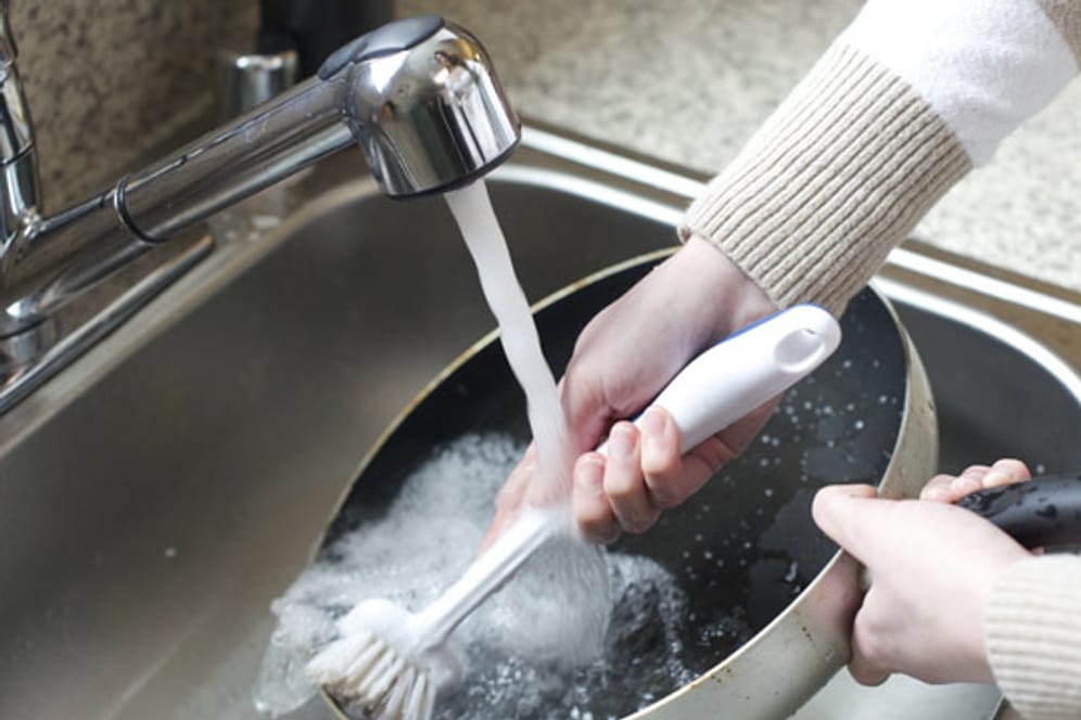Eine gusseiserne Pfanne sollten Sie mit heißem Wasser und einem Schwamm oder einer Bürste reinigen.