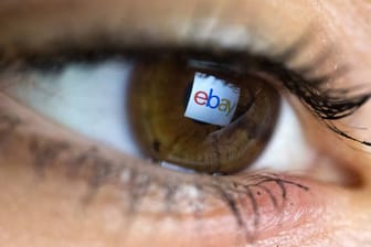 eBay-Logo spiegelt sich in der Pupille einer Frau