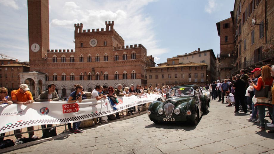 Im italienischen Siena jubeln die Zuschauer auf dem Marktplatz von Siena der Mille Miglia und diesem Healey 2400 Elliott Saloon von 1948 zu.