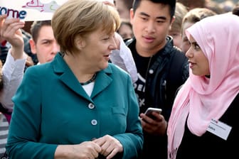 Definitionsfrage: Wie hält es Deutschland mit seinem Einwohnern mit Migrationshintergrund? Bundeskanzlerin Angela Merkel 2014 bei einem Besuch der Staatlichen Europaschule in Berlin Wilmersdorf.