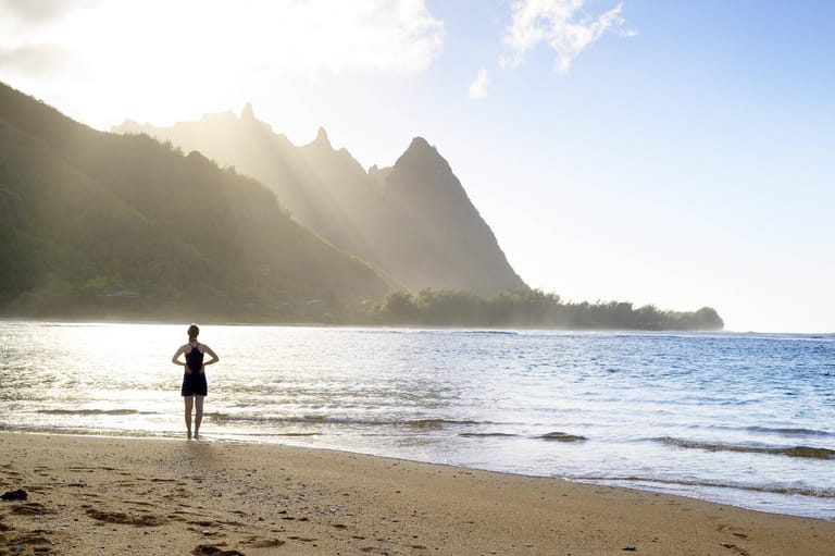 USA Hawaii Hanalei woman standing on Haena Beach View to Na Pali Coast in the evening light mode