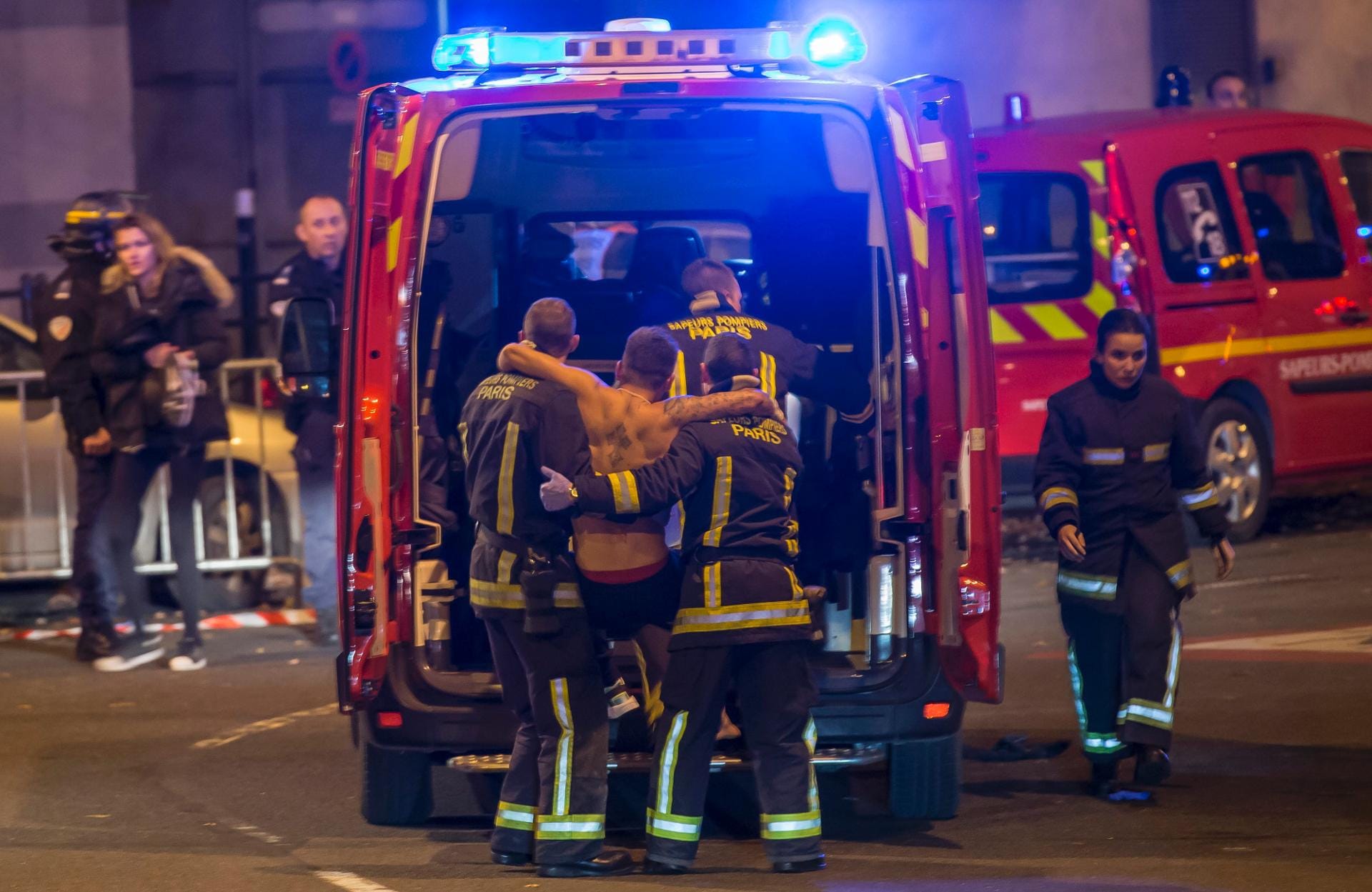 Noch während am Freitagabend das Fußballspiel Deutschland gegen Frankreich lief, gab es mehrere Explosionen in der Nähe des Stadions. Feuerwehrleute kümmerten sich um einen Verletzten.