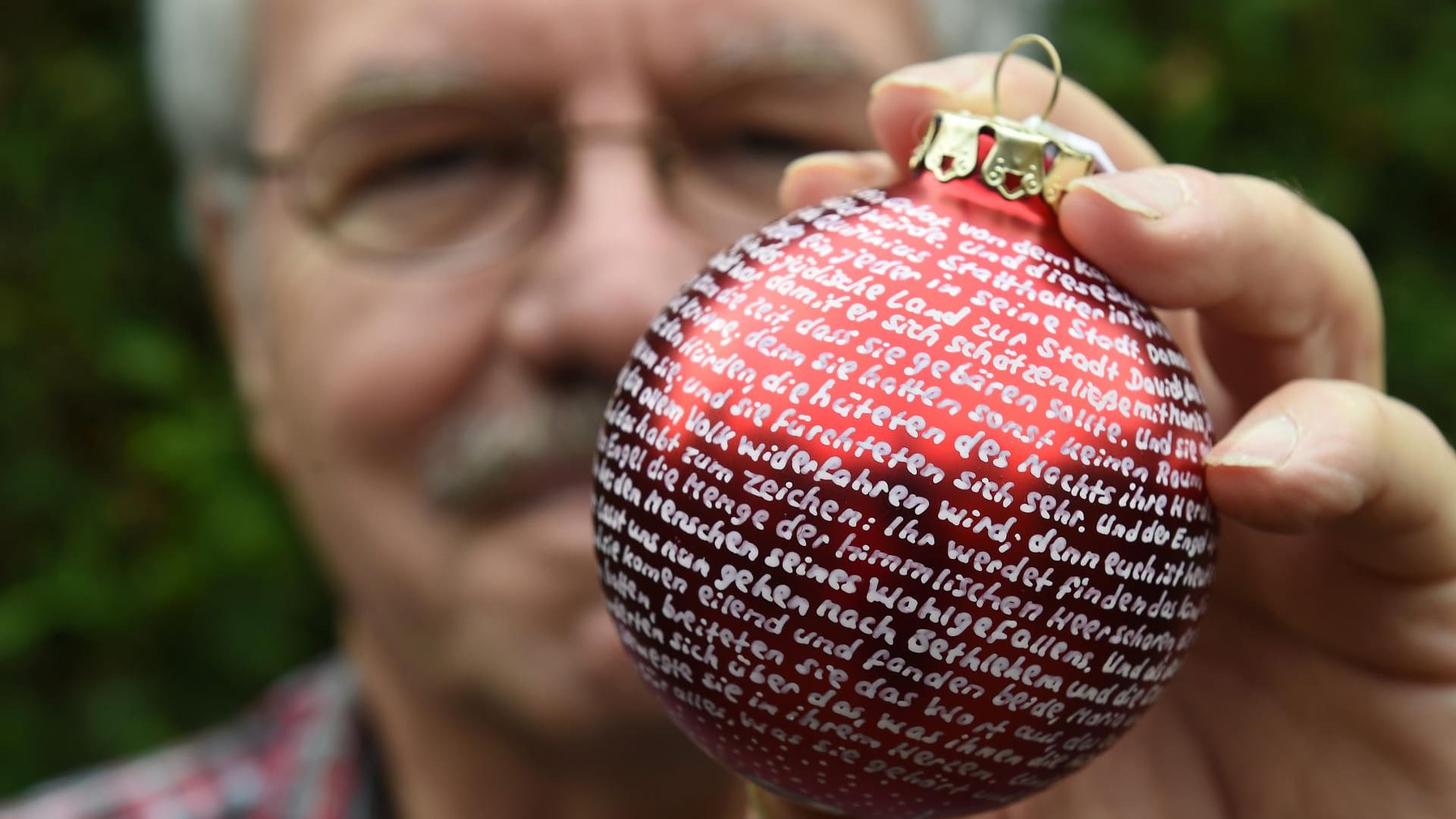 In mühevoller Handarbeit beschriftet Louis Pfeiffer Weihnachtskugeln.