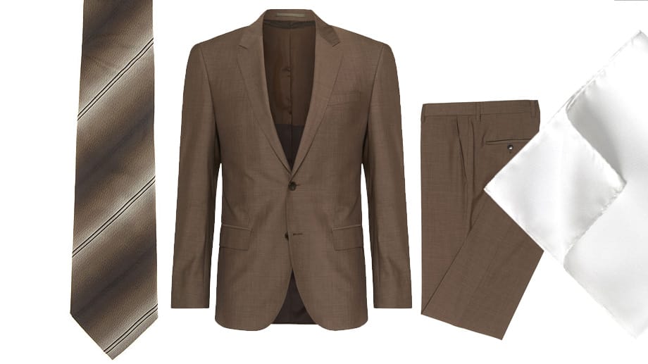 Elegant und stylish wie Don Draper in den ersten Staffeln von "Mad Men" kleiden Sie sich in dem braunen Anzug von Hugo Boss (um 499 Euro), der Krawatte von Giorgio Armani (um 124 Euro) und dem schlichten Einstecktuch von Eton (um 49 Euro).
