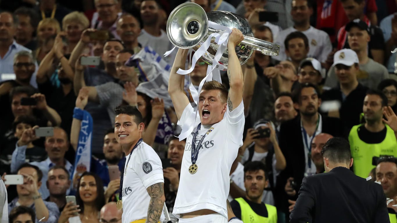 So sehen Sieger aus: Toni Kroos stemmt den Champions-League-Pokal in die Luft.