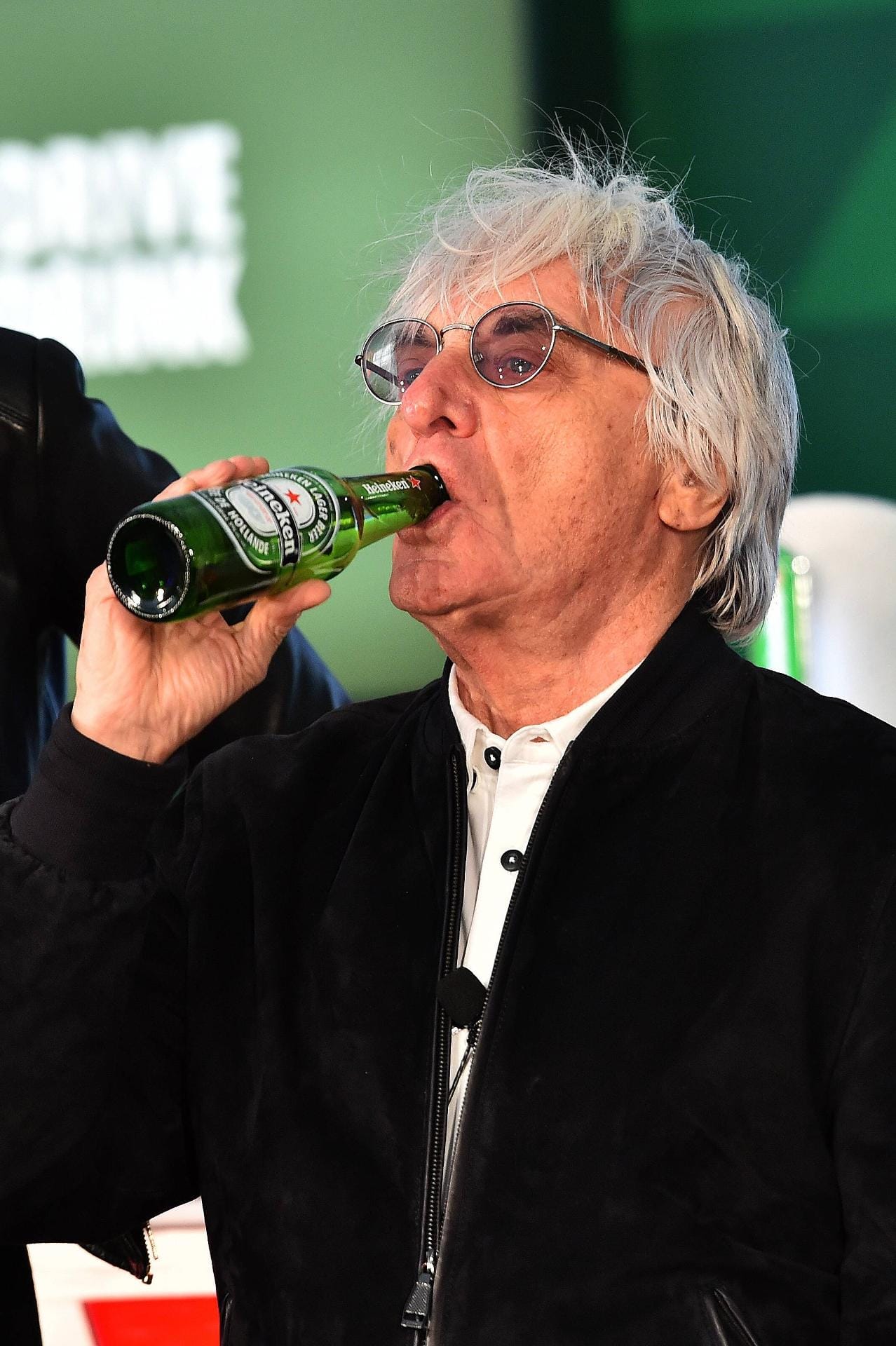 Heineken ist neuer Sponsor der Formel 1 - Bernie Ecclestone genehmigt sich darauf einen Schluck.