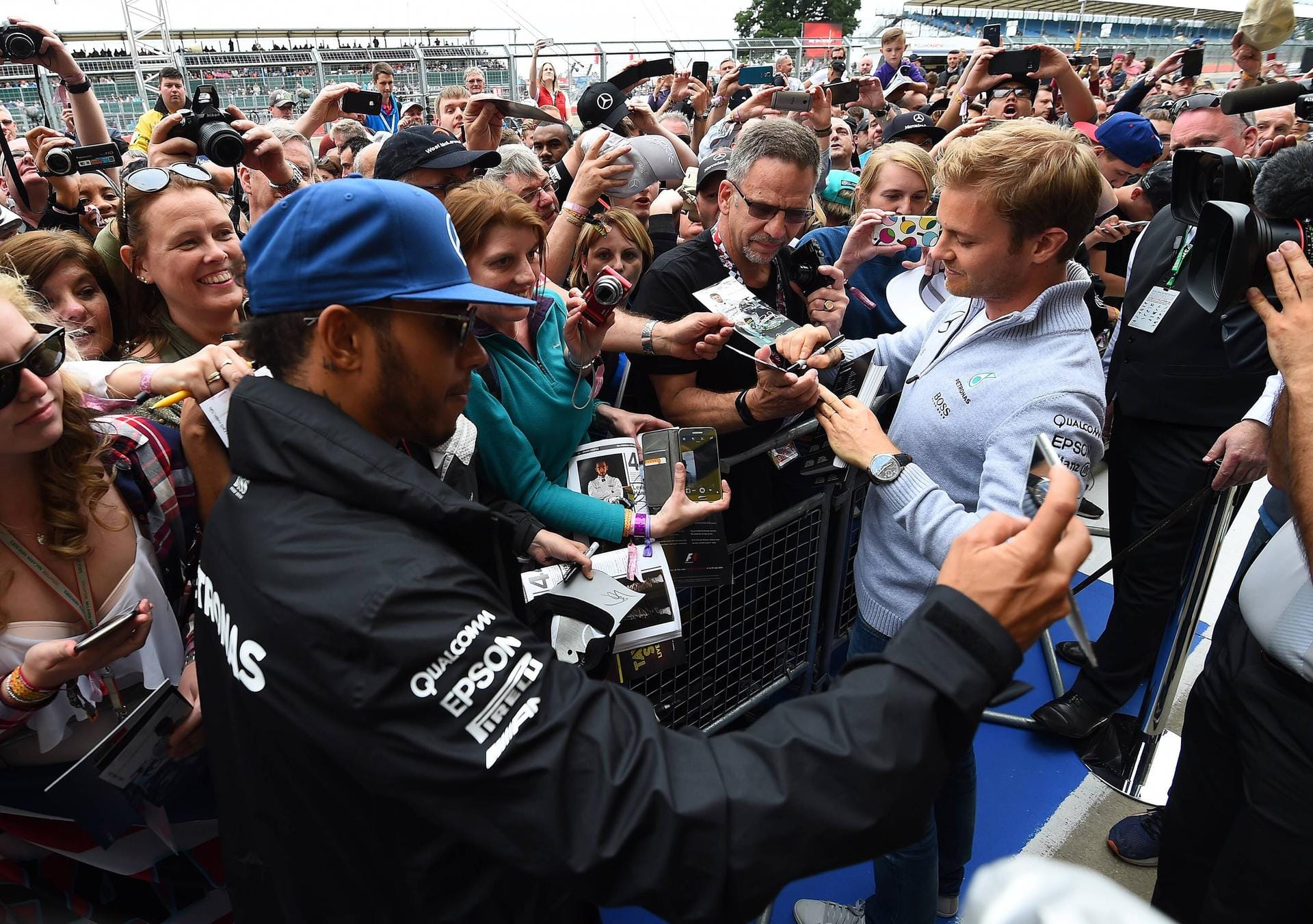 Gefragte Männer: Lewis Hamilton (links) und Nico Rosberg schreiben fleißig Autogramme.