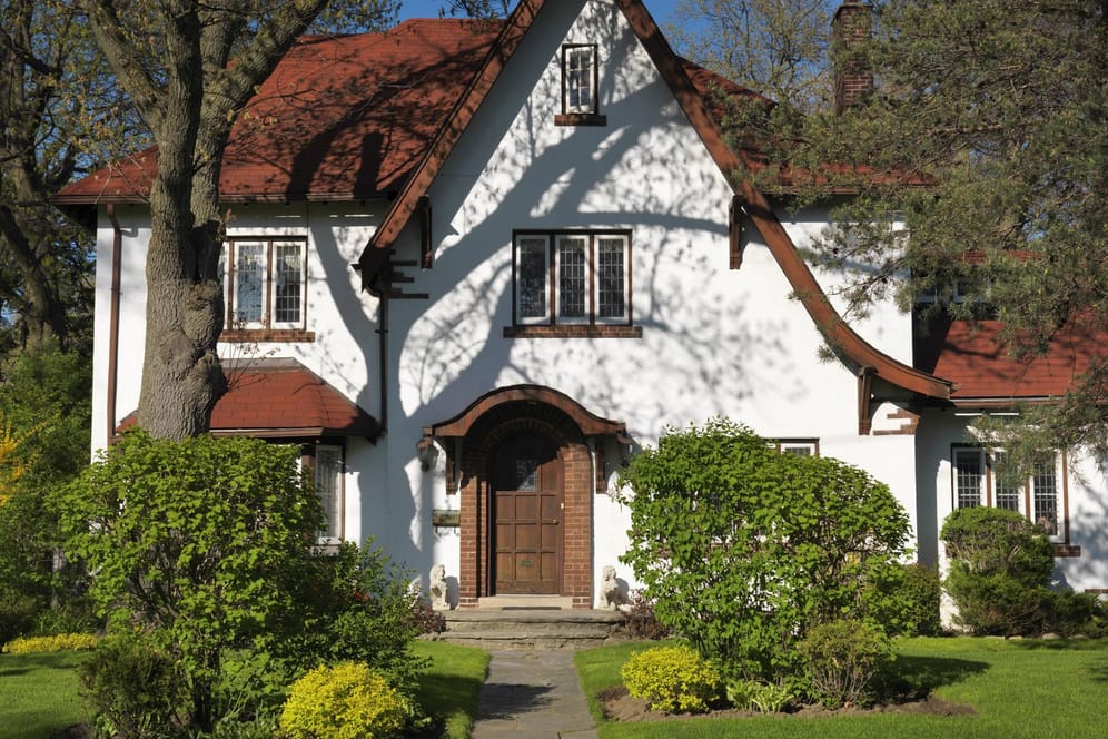 Haus mit Garten bei Sonne: Aktuell sinken die Immobilienpreise in und um die Metropolen.