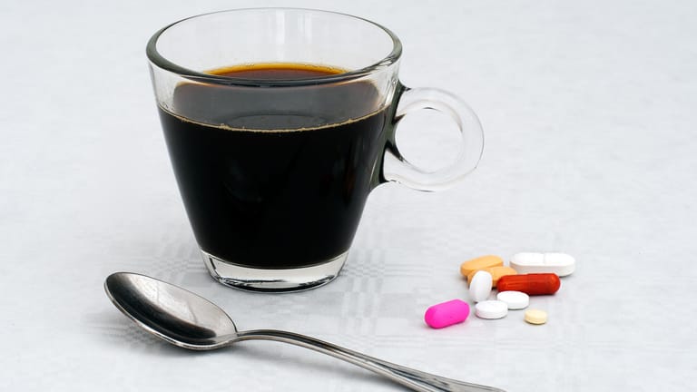 Eine Tasse Kaffee und Medikamente: Koffein und bestimmte Medikamente vertragen sich nicht. Das gilt auch für andere Lebensmittel.