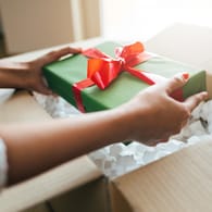 Close up of hands holding gift box