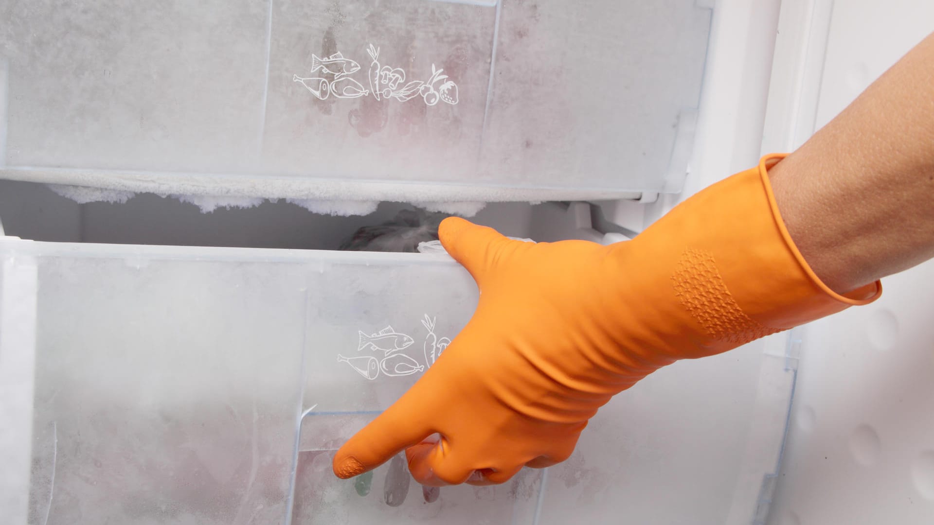 Hand in glove opening refrigerator.