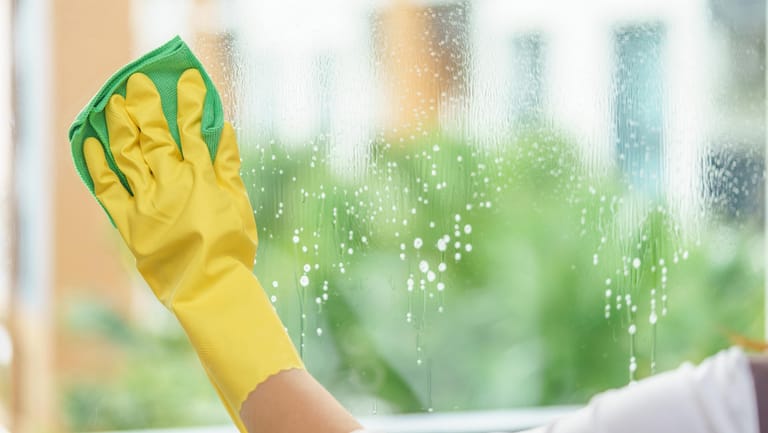 Ob Glasreiniger oder Spülmittel: Tragen Sie beim Fenster putzen Handschuhe, um Ihre Hände vor dem Austrocknen zu schützen.