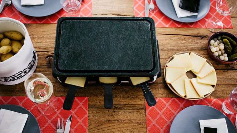 Raclette: Wie Sie die Grillplatte reinigen, hängt vor allem von ihrem Material ab.