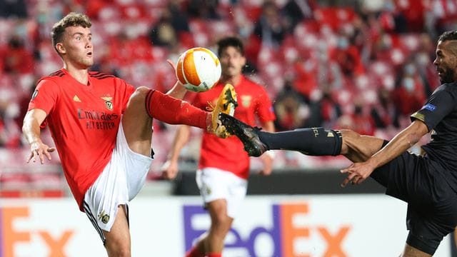 Benficas Luca Waldschmidt (l) und Standards Mehdi Carcela gehen mit gestrecktem Bein zum Ball. Benficas Luca Waldschmidt (l) und Standards Mehdi Carcela gehen mit gestrecktem Bein zum Ball.