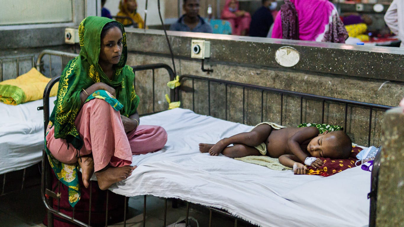 Mutter mit ihrem Kind: Immer wieder erkranken Menschen in Indien an dem Dengue-Virus (Symbolbild).