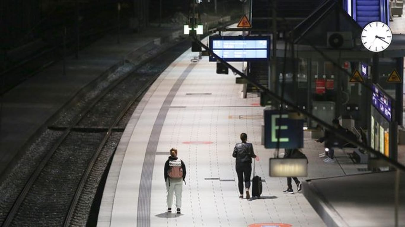 Reisende warten am Hamburger Hauptbahnhof auf den Zug