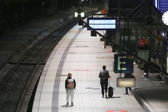 Reisende warten am Hamburger Hauptbahnhof auf den Zug